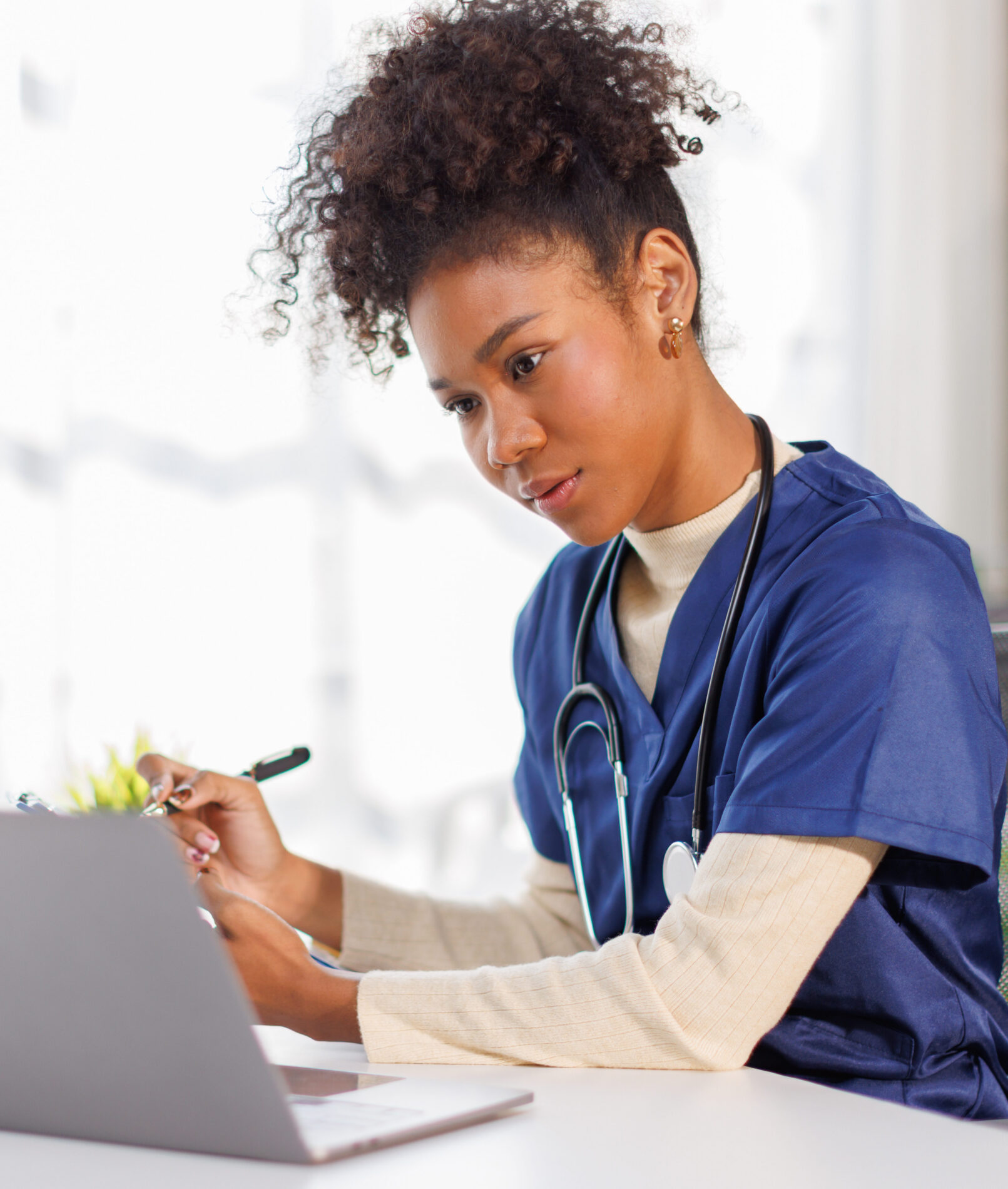 Clinician working on a laptop.