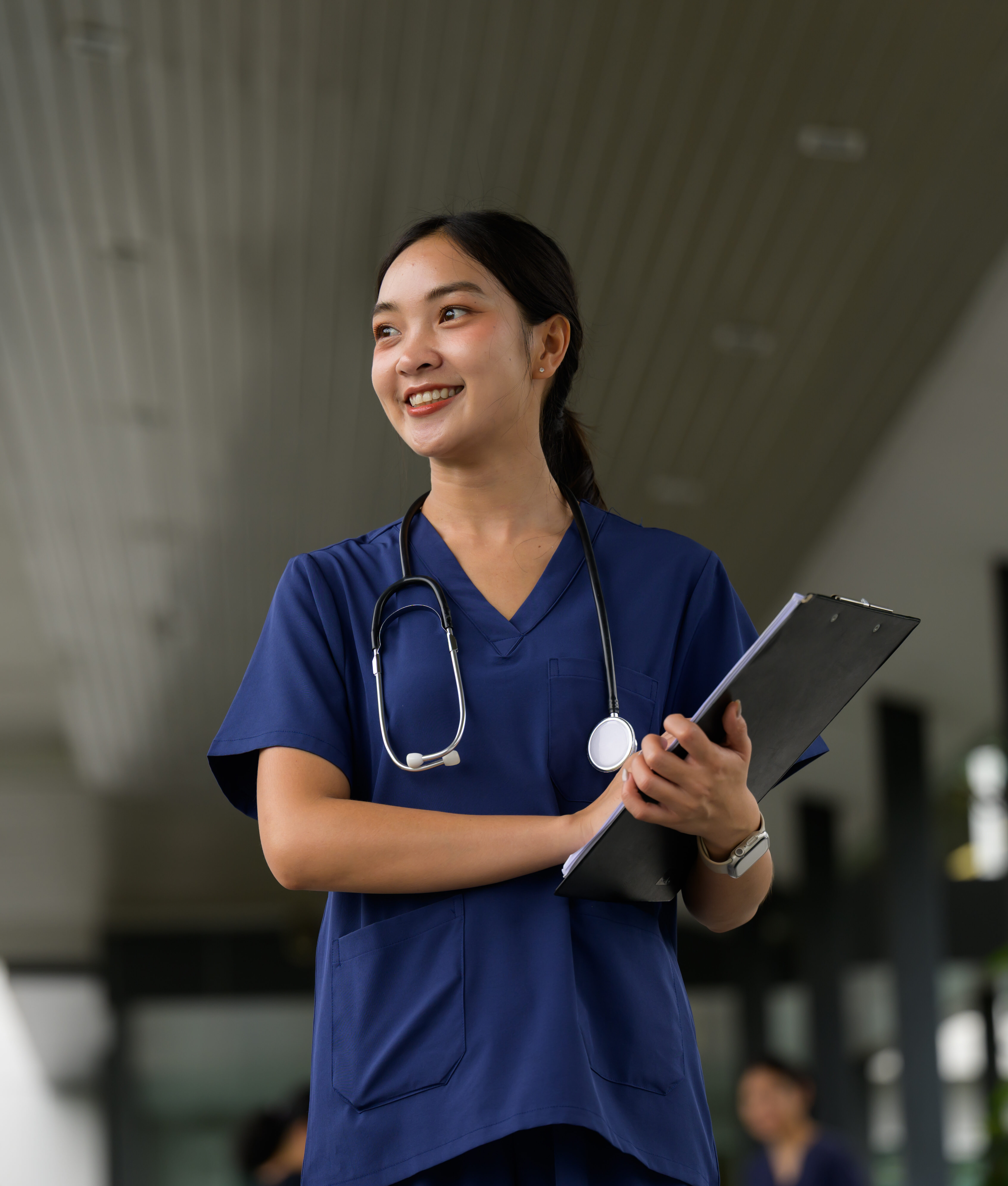 Clinician holding a clipboard, smiling.