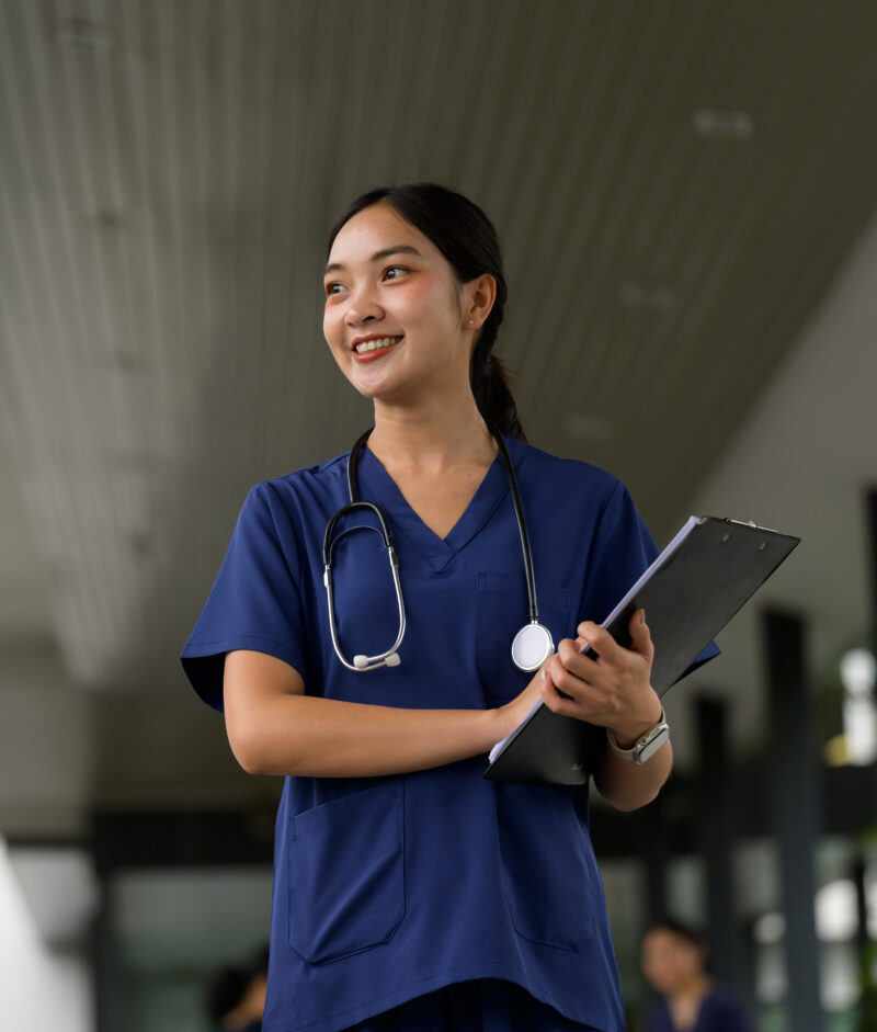 Clinician holding a clipboard, smiling.
